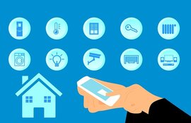 Symbole, die technische Geräte abbilden und eine Hand, die ein Smartphone in den Händen hält