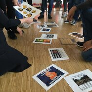 Memes, die auf Papier abgebildet sind und von Menschen in einem Workshop diskutiert werden