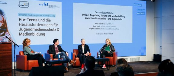 Speakers on stage at the conference "Between children's programmes & social media: Pre-teens and the challenges for youth media protection and media literacy"